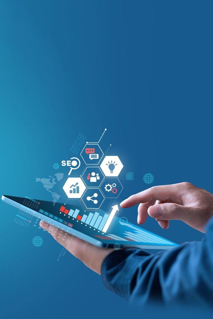 “Hand using a tablet with digital marketing and analytics icons floating above.”