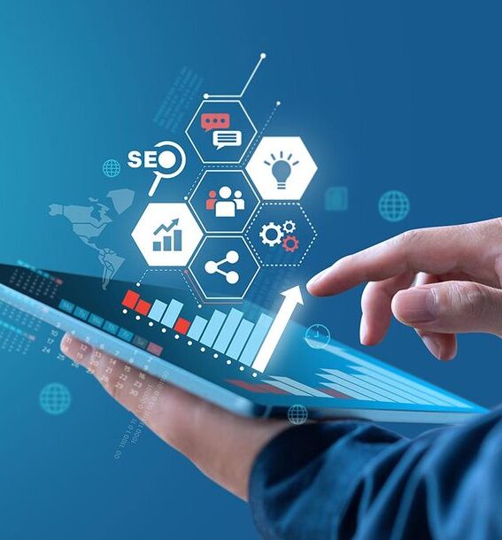 “Hand using a tablet with digital marketing and analytics icons floating above.”